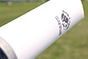 A close up of the side of a white baseball bat.