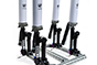 A group of four telescopic arms holding up two large cylinders.