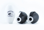 A pair of black and white earbuds next to a bottle.